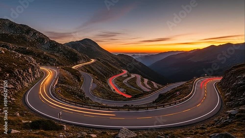 Winding Mountain Road with Dynamic Car Light Trails at Scenic Sunset
