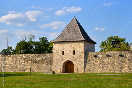 Medieval stone gate and tower entrance of historic fortress, showcasing traditional architecture, defensive design, and preserved cultural heritage under bright daylight.