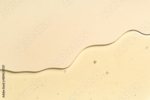 Tableau sur toile Texture of cosmetic oil on beige background