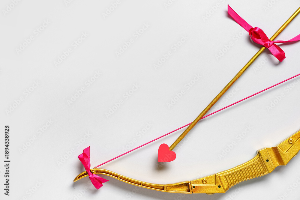 Fototapeta premium Beautiful golden cupid's bow on white background. Valentine's Day celebration