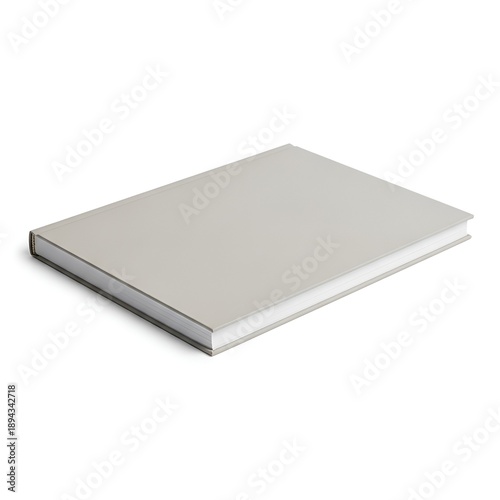 A closed silver metal notebook lies flat on a plain surface from a slightly elevated viewpoint