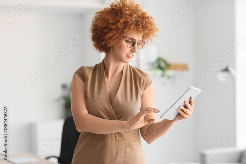Redhead businesswoman worki...
