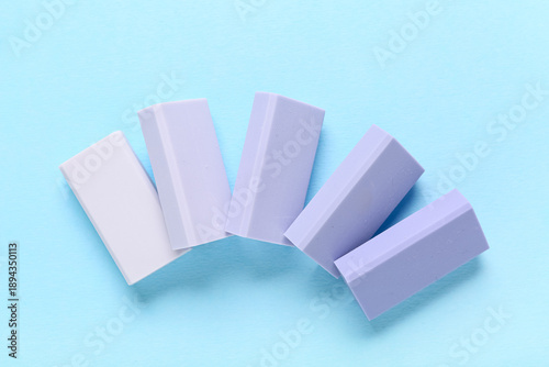 Lilac rubber erasers on blu...
