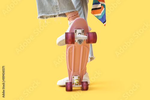 Young woman riding skateboa...