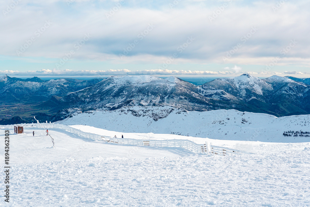 Fototapeta premium Snowy mountain landscape at Valgrande-Pajares ski resort in northern Spain, close view of snow-covered peaks and panoramic views from the top of the mountain