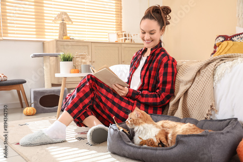 Young woman reading book wi...
