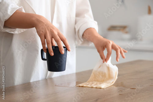Woman wiping spilled coffee...