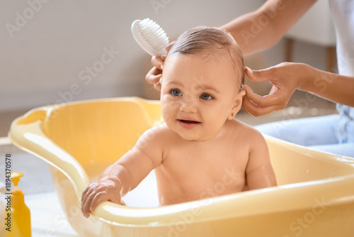 Mother brushing her baby's ...