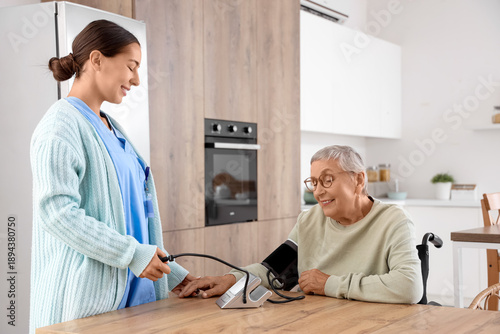 Female caregiver measuring ...