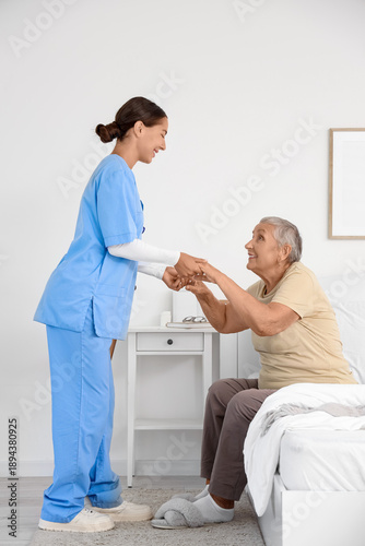 Female caregiver helping ha...
