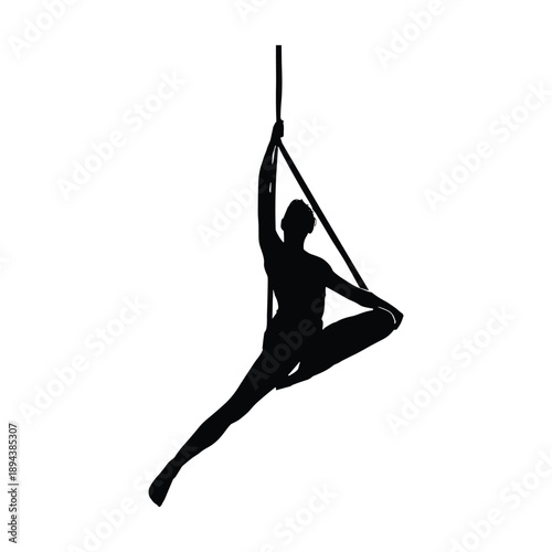 Silhouette of aerial dancer performing split pose