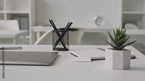 Modern Office Desk with Laptop, Pencils, and Plant.