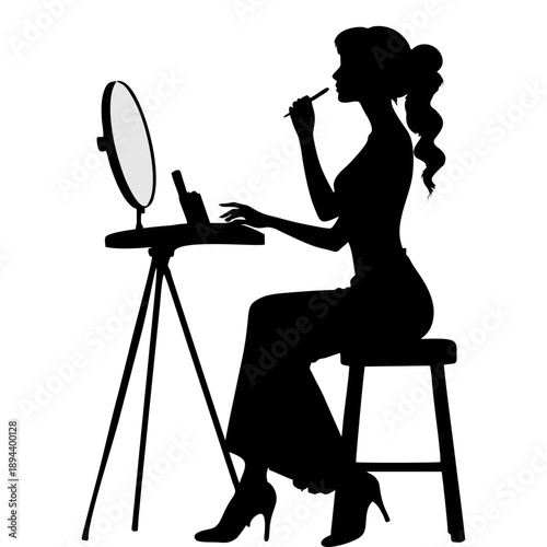 Black silhouette of a woman applying makeup at a dressing table