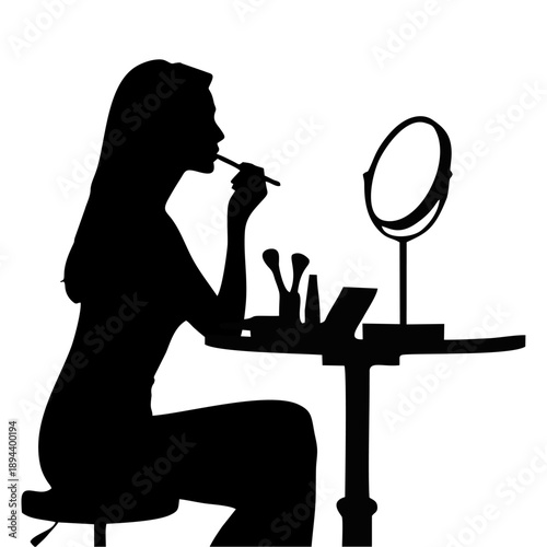 Black silhouette of a woman applying makeup at a dressing table