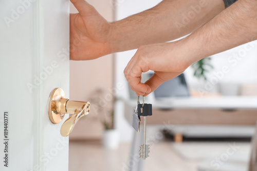 Male hands with key from ho...