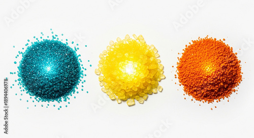 Three colorful piles of bath salts, blue, yellow, orange, isolated on transparent background