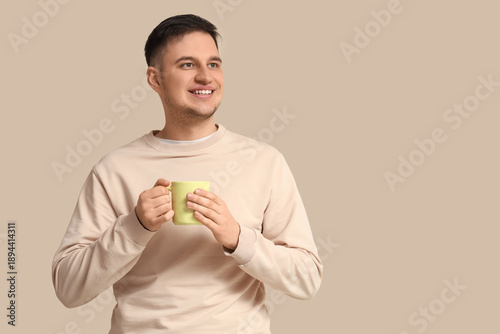 Handsome young man with mug...