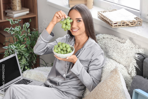 Young woman in pajamas with...