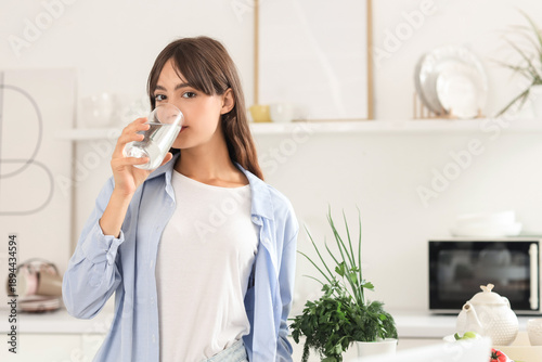 Young woman drinking water ...