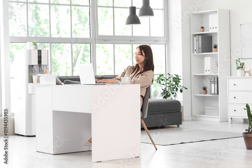 Asian businesswoman working...