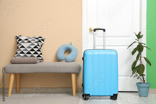 Blue suitcase and neck pill...