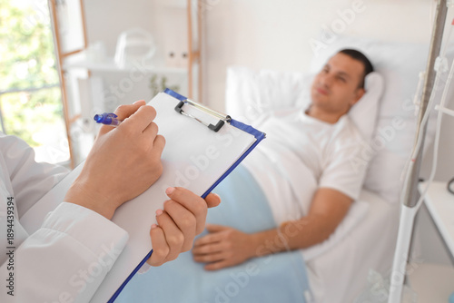 Female doctor writing on cl...
