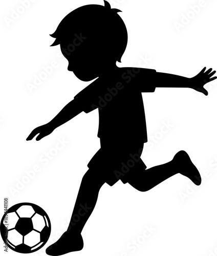 Silhouette of young boy playing soccer, joyfully kicking ball