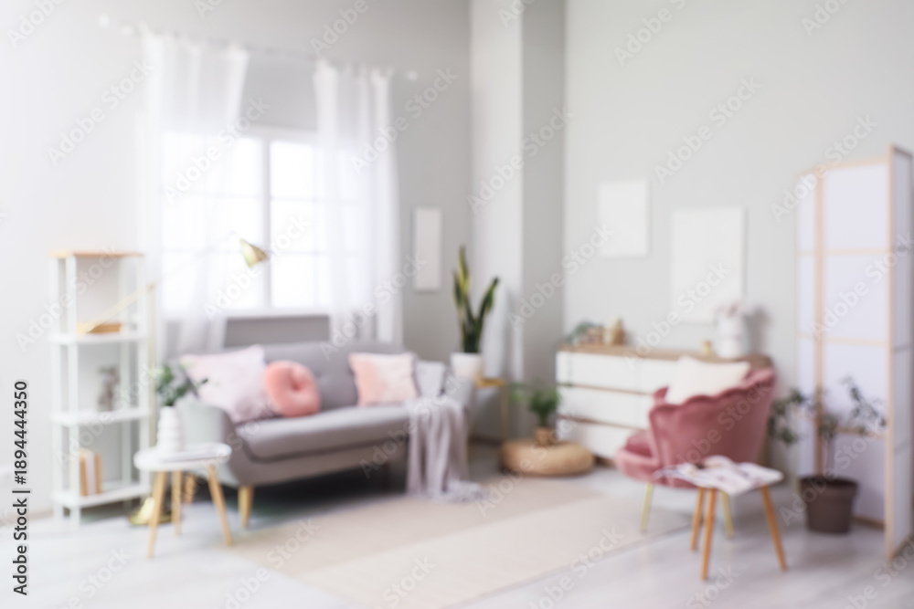 Fototapeta premium Cozy sofa with pillows, plaid and armchair with cushion in living room