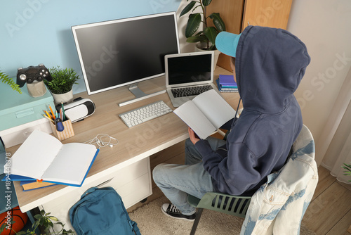 Teenage boy with copybook s...