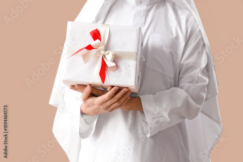 Young Muslim man with gift ...