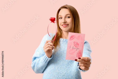 Happy young woman holding g...