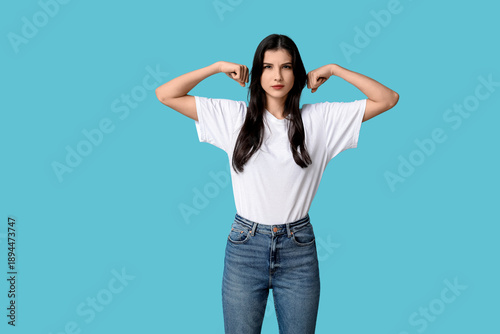 Young woman flexing muscles...