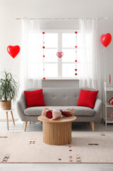 Interior of modern living room bouquet of roses on coffee table and decorations for Valentine's Day celebration