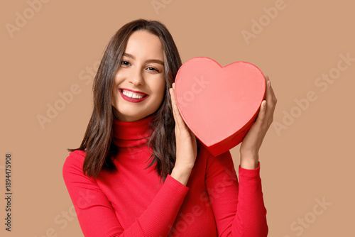 Happy young woman with gift...