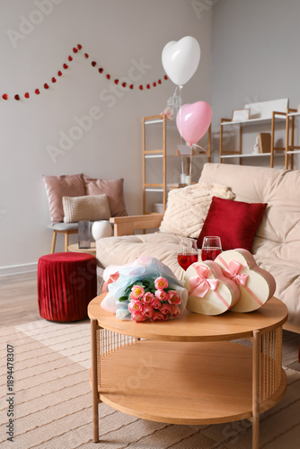 Interior of living room decorated for Valentine's Day with sofa, roses and gifts