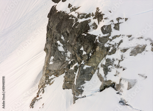 Wallpaper Mural Steep Snowy Cliffs and Jagged Rock Face Clinging to a Snowbound Mountain Slope Torontodigital.ca