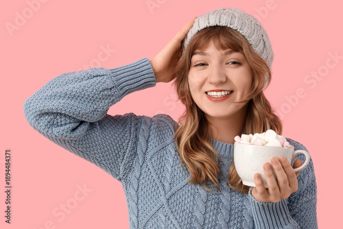 Pretty young woman holding ...
