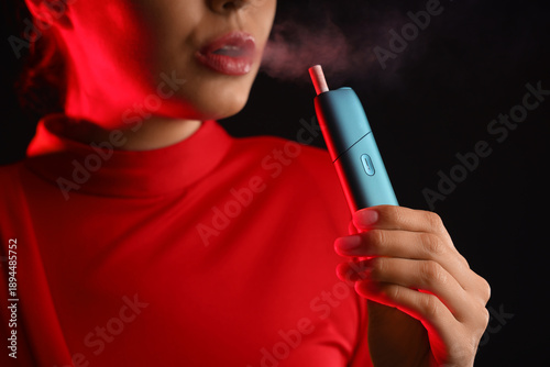 Young woman smoking electro...