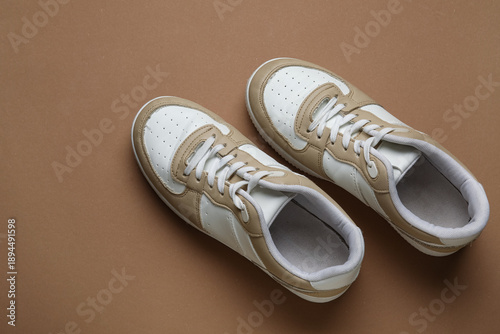 Stylish sneakers on brown b...