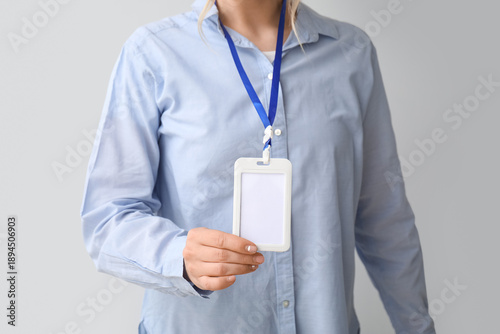 Young woman with blank badg...
