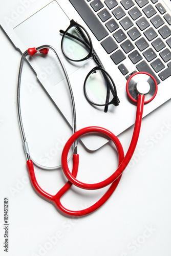 Stethoscope, laptop and gla...