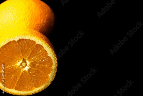 Juicy citrus fruit halves isolated on dark background