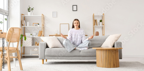 Young woman meditating on s...