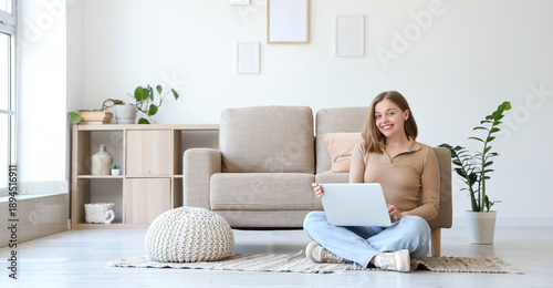 Young woman using laptop on...