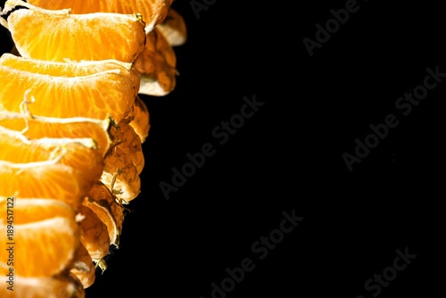 mandarin segments on dark background, juicy citrus