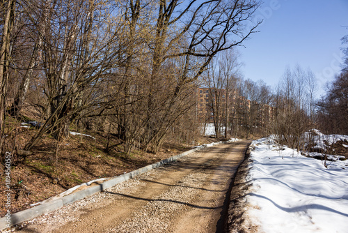 Obraz na płótnie New urban path taking shape: freshly installed curbs line a gravel road, blendin
