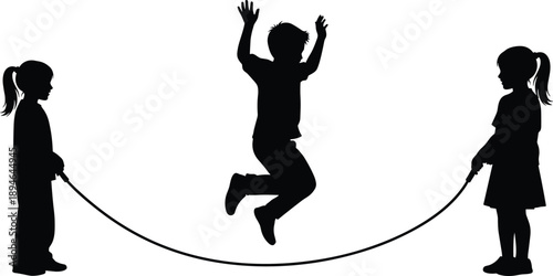 Black silhouette of children playing jump rope with a young boy jumping while two girls hold the rope on white background