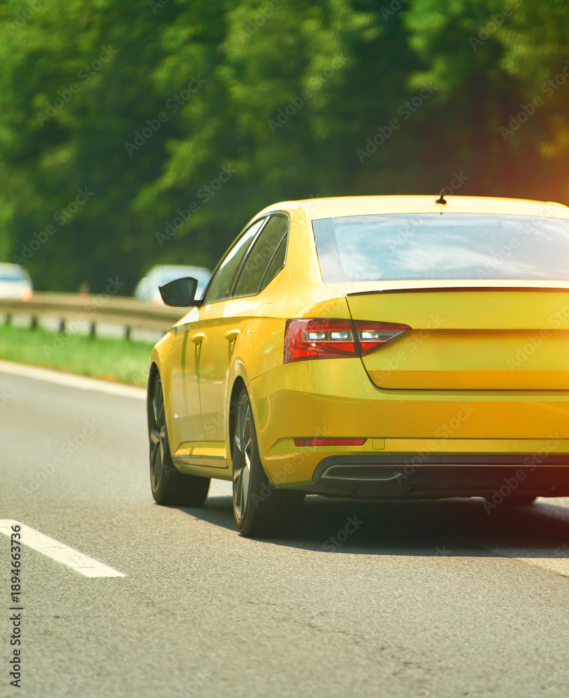Fototapeta premium Yellow car driving on highway road