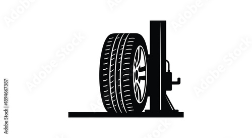 A stark black silhouette depicts a tire and jack likely representing automotive repair or maintenance silhouette high quality