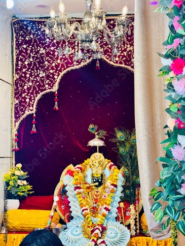 Lord Sanwariya Seth Ji Idol in Temple, Detailed Decoration with Flowers and Peacock Feathers.